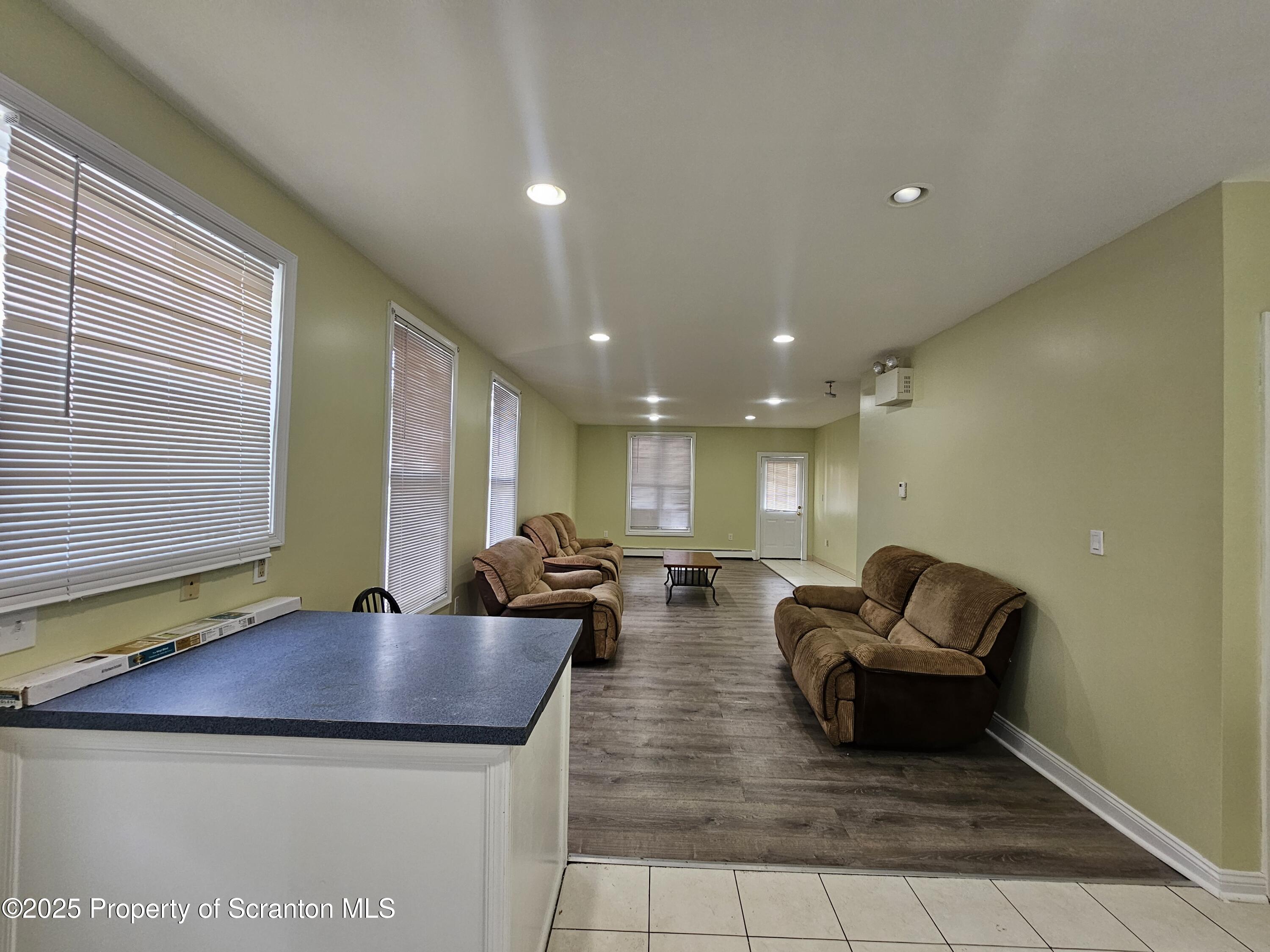 1207 Mulberry Street Scranton, PA 18510 - Photo 4 of 21 a living room with couches and kitchen view with wooden floor