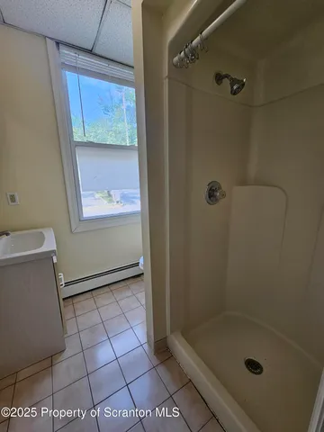 a bathroom with a glass shower door