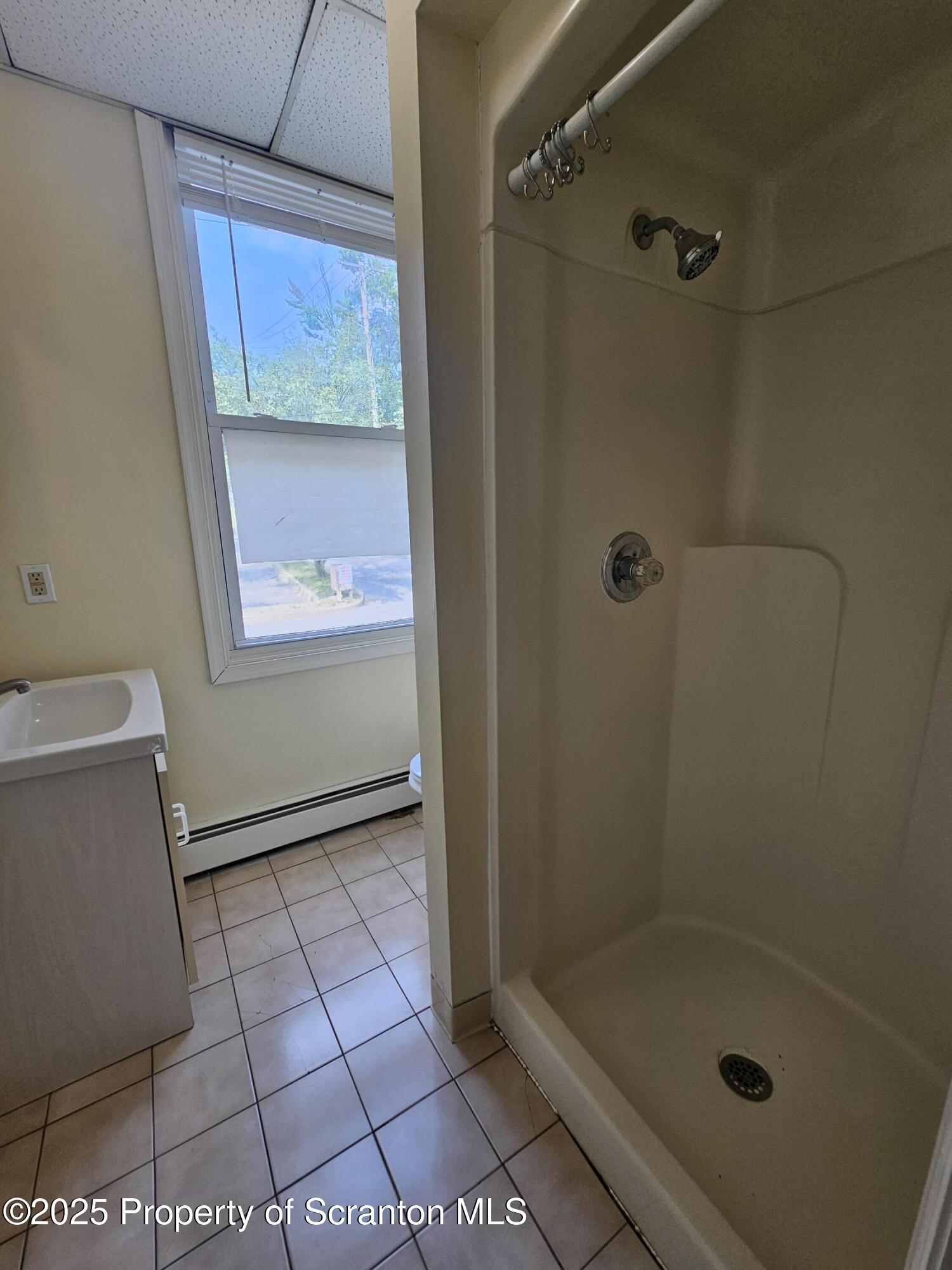 1207 Mulberry Street Scranton, PA 18510 - Photo 8 of 21 a bathroom with a glass shower door
