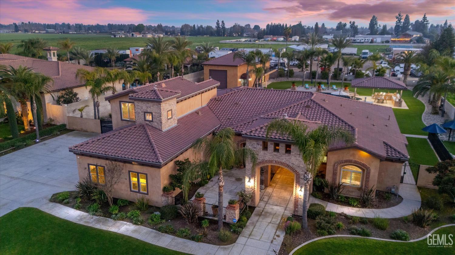 an aerial view of a house with a garden and mountain view in back