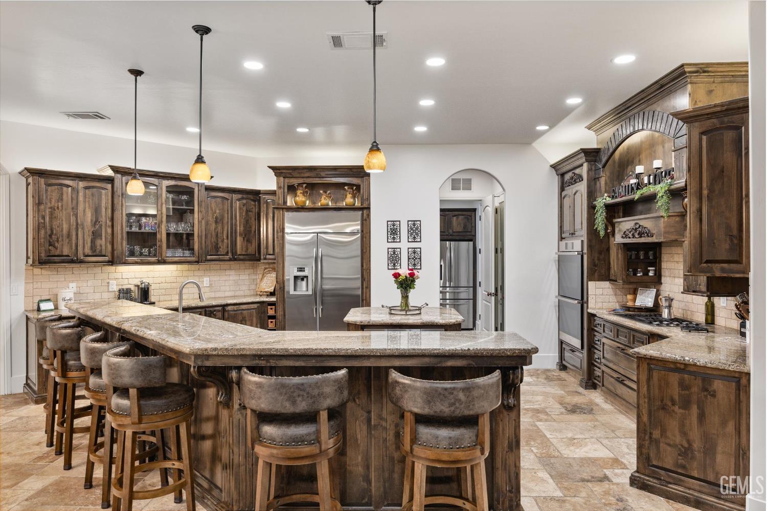 Undisclosed Address Bakersfield, CA 93314 - Photo 16 of 59 a kitchen with granite countertop a table and chairs in it