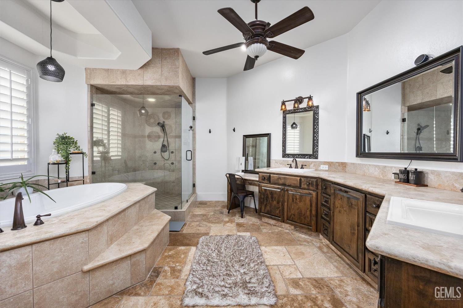 Undisclosed Address Bakersfield, CA 93314 - Photo 23 of 59 a large spacious bathroom with a double vanity sink a mirror and a bathtub