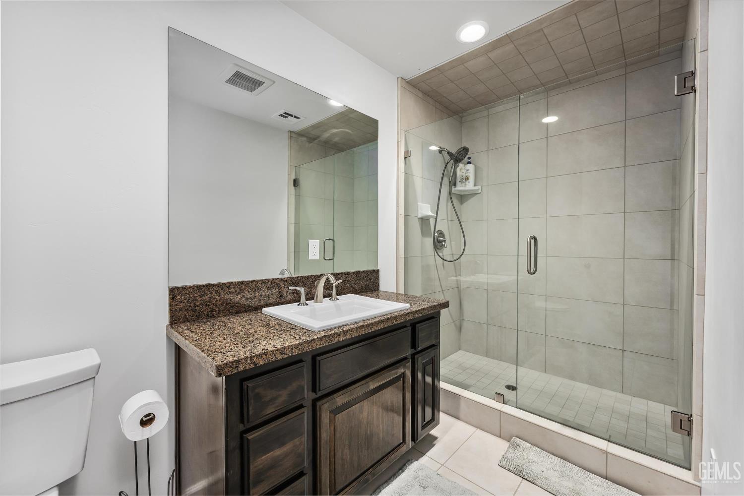 Undisclosed Address Bakersfield, CA 93314 - Photo 46 of 59 a bathroom with a sink a toilet and shower