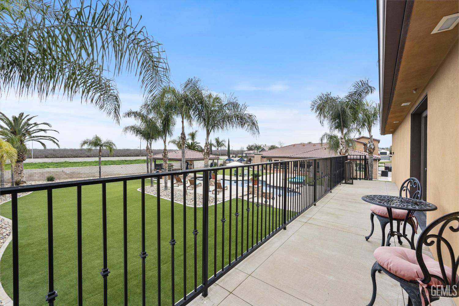 Undisclosed Address Bakersfield, CA 93314 - Photo 47 of 59 a view of a swimming pool with a table and chairs