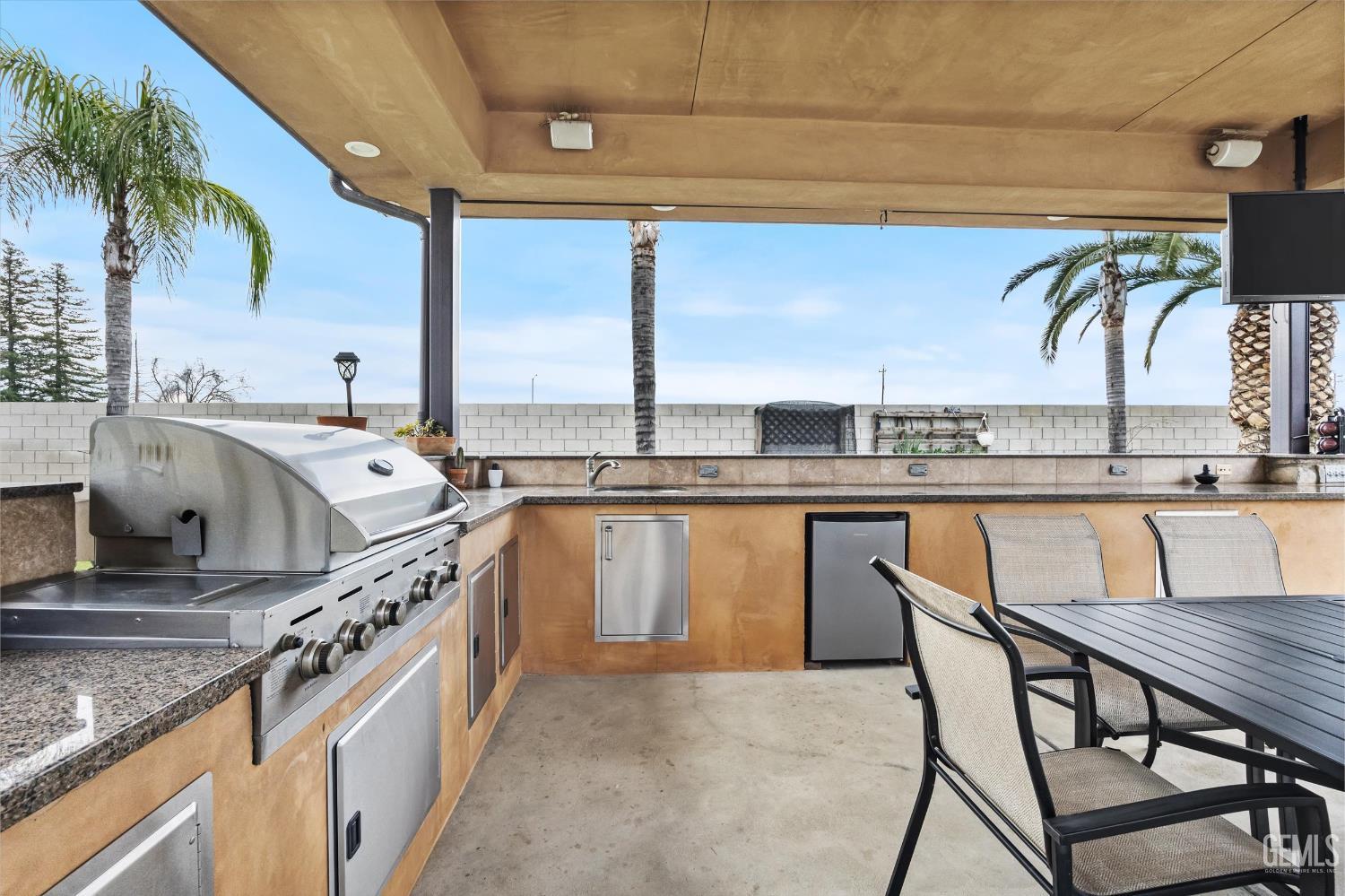 Undisclosed Address Bakersfield, CA 93314 - Photo 50 of 59 a kitchen with a table chairs sink and cabinets