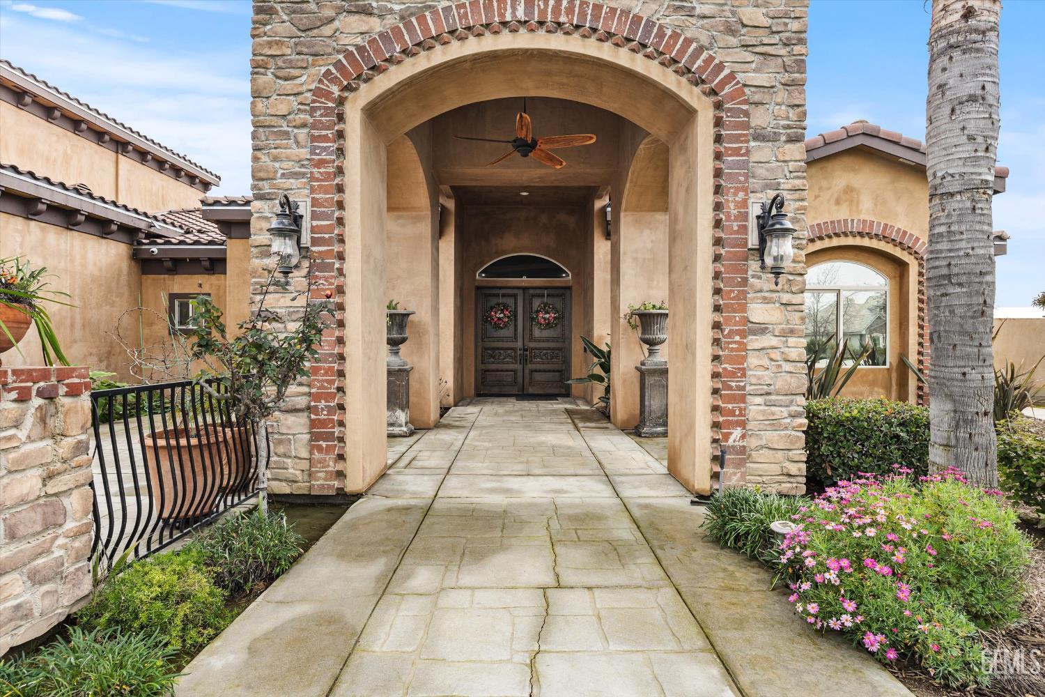 Undisclosed Address Bakersfield, CA 93314 - Photo 8 of 59 a front view of a house with a garden