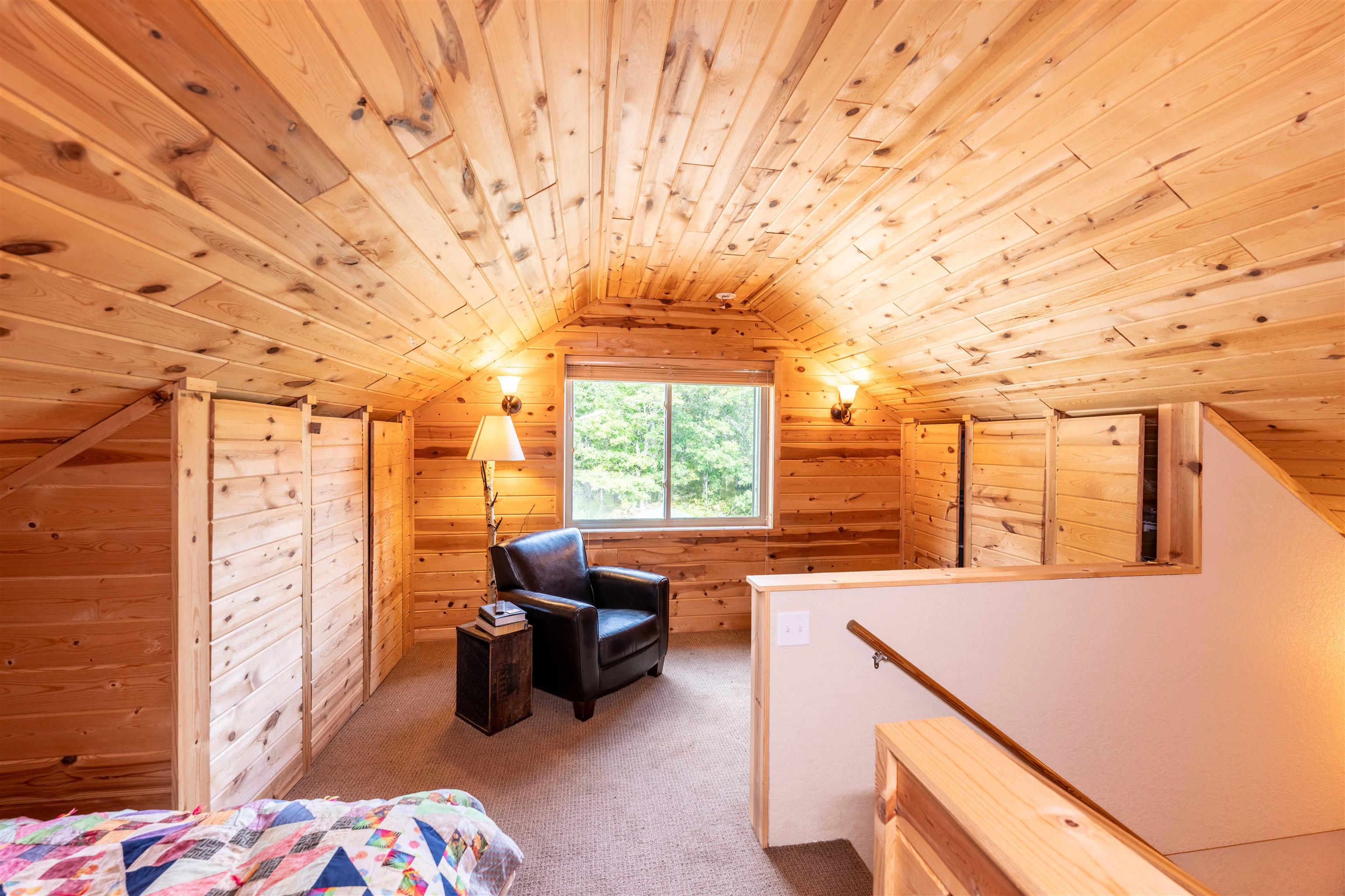54755 Silverwolf Drive Barnes, WI 54873 - Photo 8 of 18 Upstairs bedroom with warm wood finishes and cozy charm