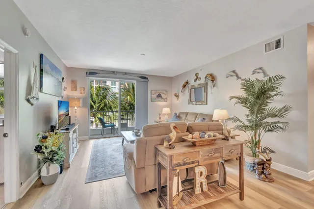 a view of a balcony with chairs and a potted plant