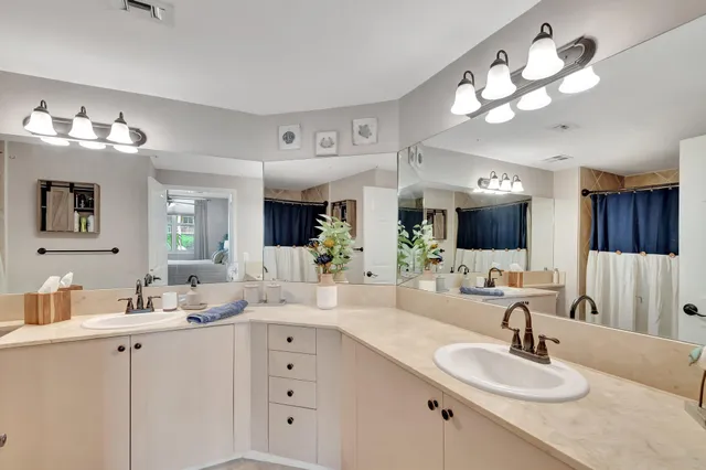 a bedroom with a bed and a lamp on dresser