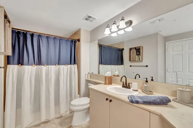 a bedroom with a bed dresser and a window