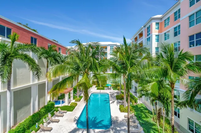 a view of a chair and table in backyard with potted plants