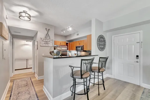 a living room with furniture a flat screen tv and a floor to ceiling window