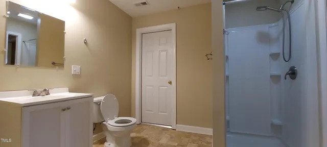 a bathroom with a sink toilet and shower