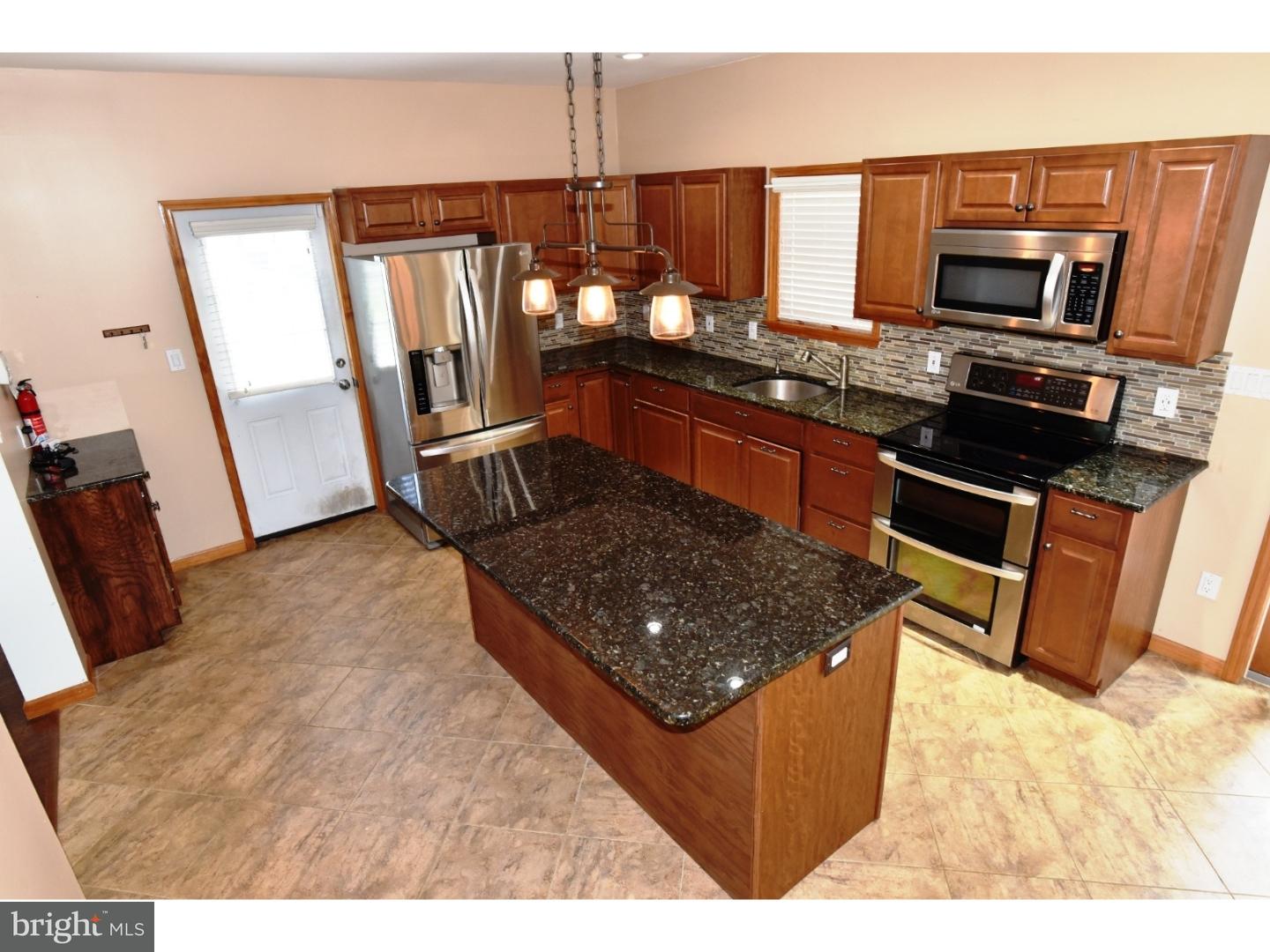529 Province Line Road Allentown, NJ 08501 - Photo 2 of 21 a kitchen with stainless steel appliances granite countertop a stove top oven and sink