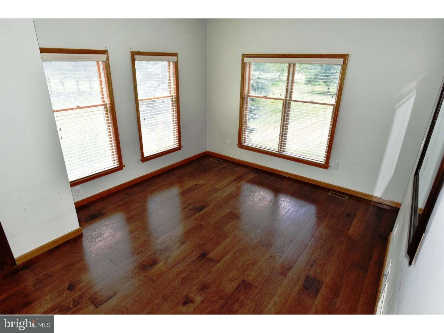 529 Province Line Road Allentown, NJ 08501 - Photo 5 of 21 an empty room with wooden floor and windows