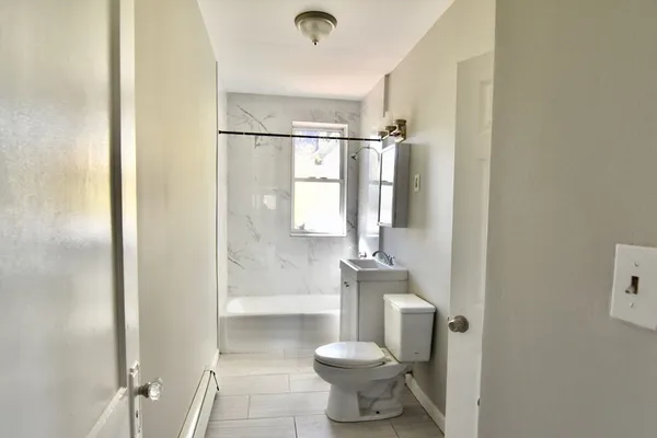 a bathroom with a toilet and a shower
