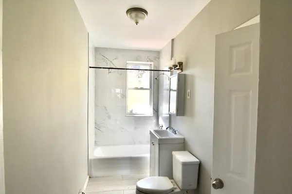a bathroom with a toilet a sink and shower