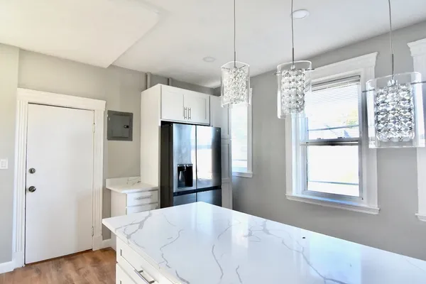 a kitchen with stainless steel appliances a refrigerator and microwave