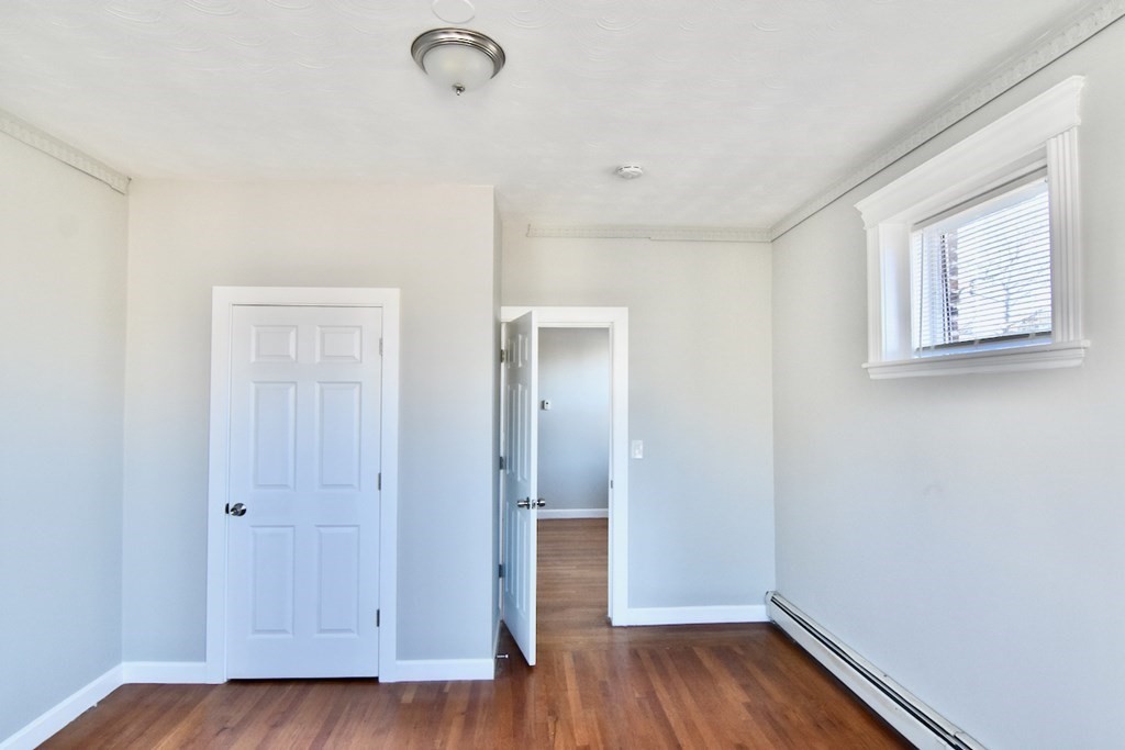 103 Homestead Street, Unit 1 Boston, MA 02121 - Photo 9 of 16 a view of an empty room with wooden floor