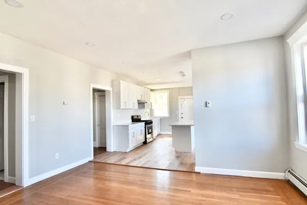 a view of a kitchen with wooden floor
