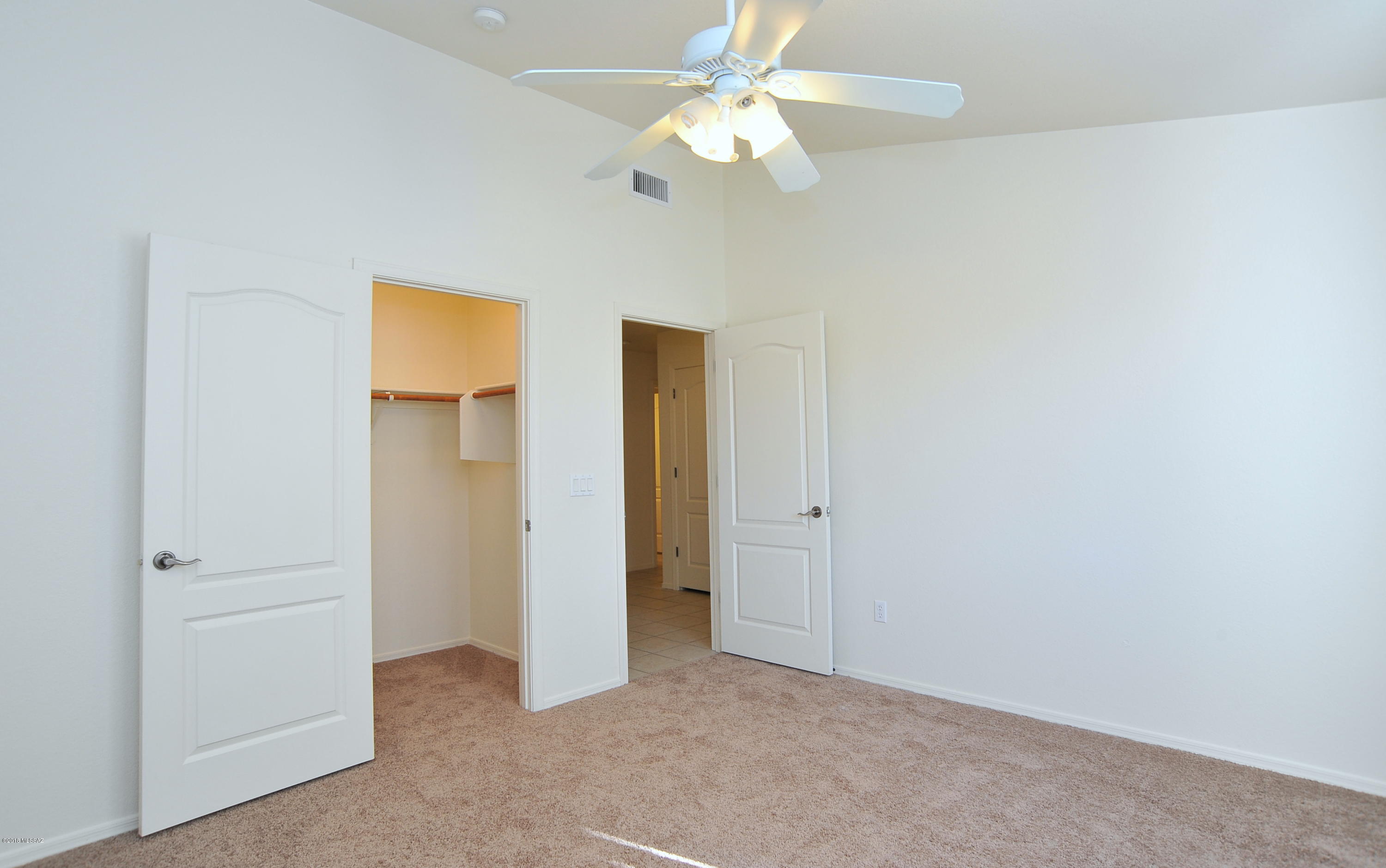 558 West Chatfield Street Vail, AZ 85641 - Photo 22 of 31 an empty room with a ceiling fan and a window
