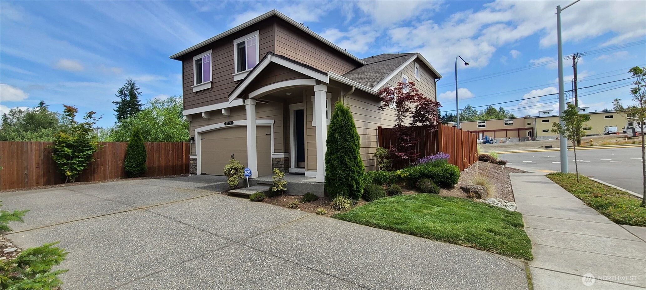 3721 202nd Pl S East Bothell, WA 98012 - Photo 3 of 23 a front view of a house with a yard and garage