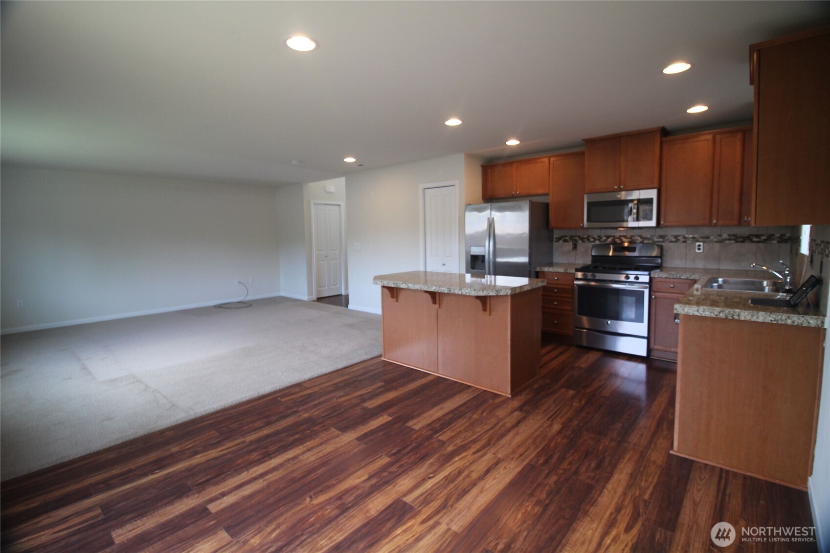 3721 202nd Pl S East Bothell, WA 98012 - Photo 7 of 23 a kitchen with stainless steel appliances kitchen island granite countertop a stove a sink and a refrigerator