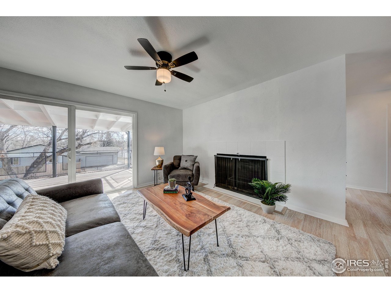 2017 Evergreen Drive Fort Collins, CO 80521 - Photo 14 of 33 a living room with furniture a flat screen tv and a large window