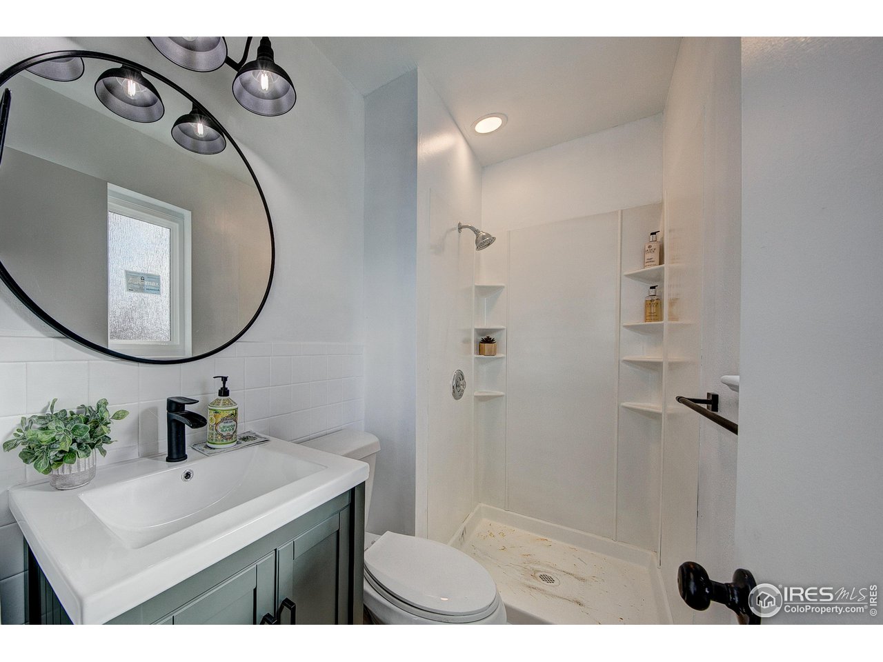 2017 Evergreen Drive Fort Collins, CO 80521 - Photo 17 of 33 a bathroom with a sink a mirror and a shower