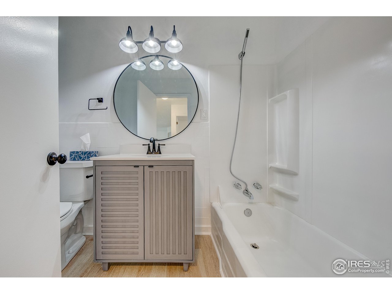 2017 Evergreen Drive Fort Collins, CO 80521 - Photo 22 of 33 a bathroom with a sink a mirror and a bathtub