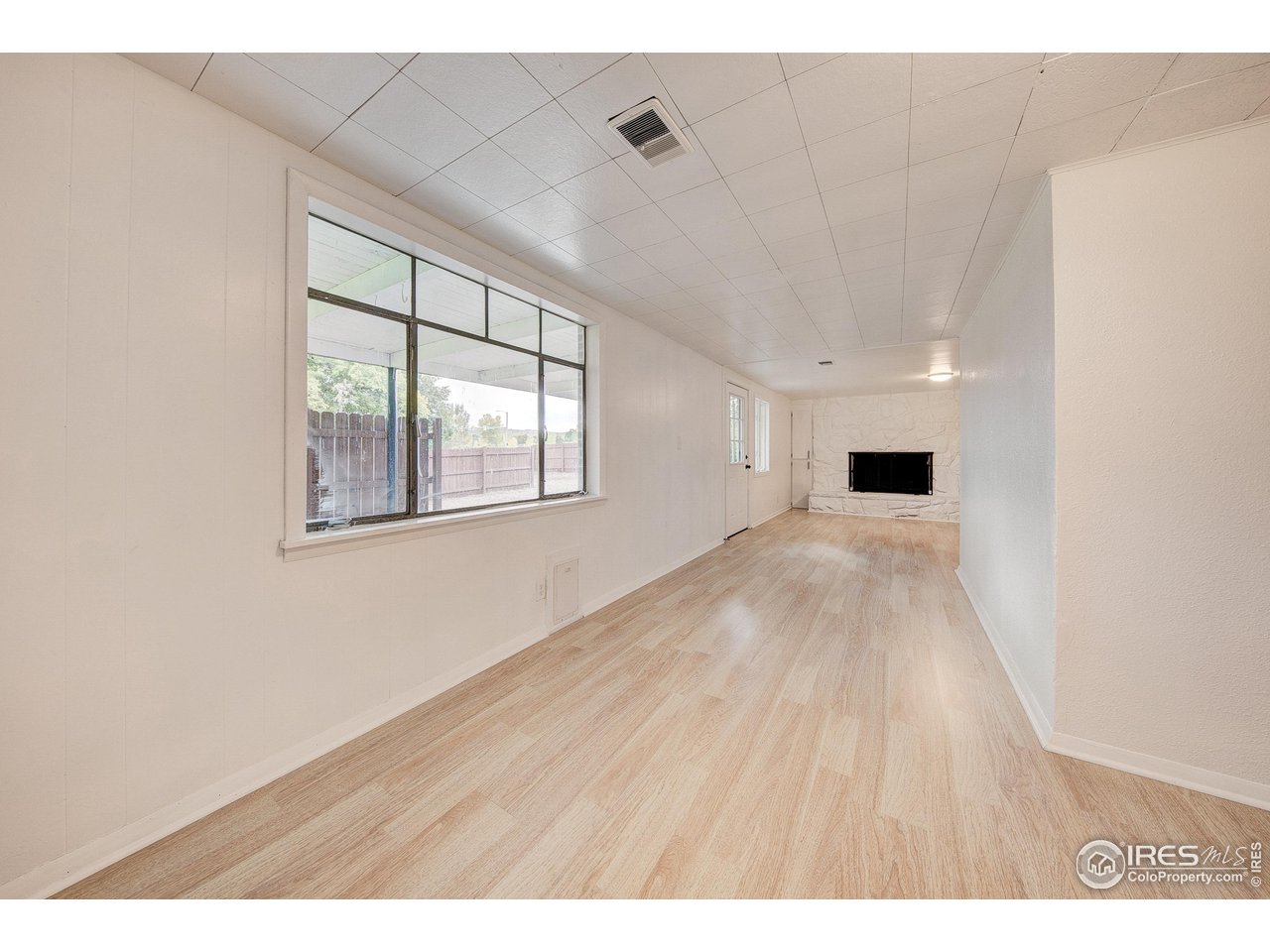 2017 Evergreen Drive Fort Collins, CO 80521 - Photo 30 of 33 a view of an empty room with wooden floor and a window