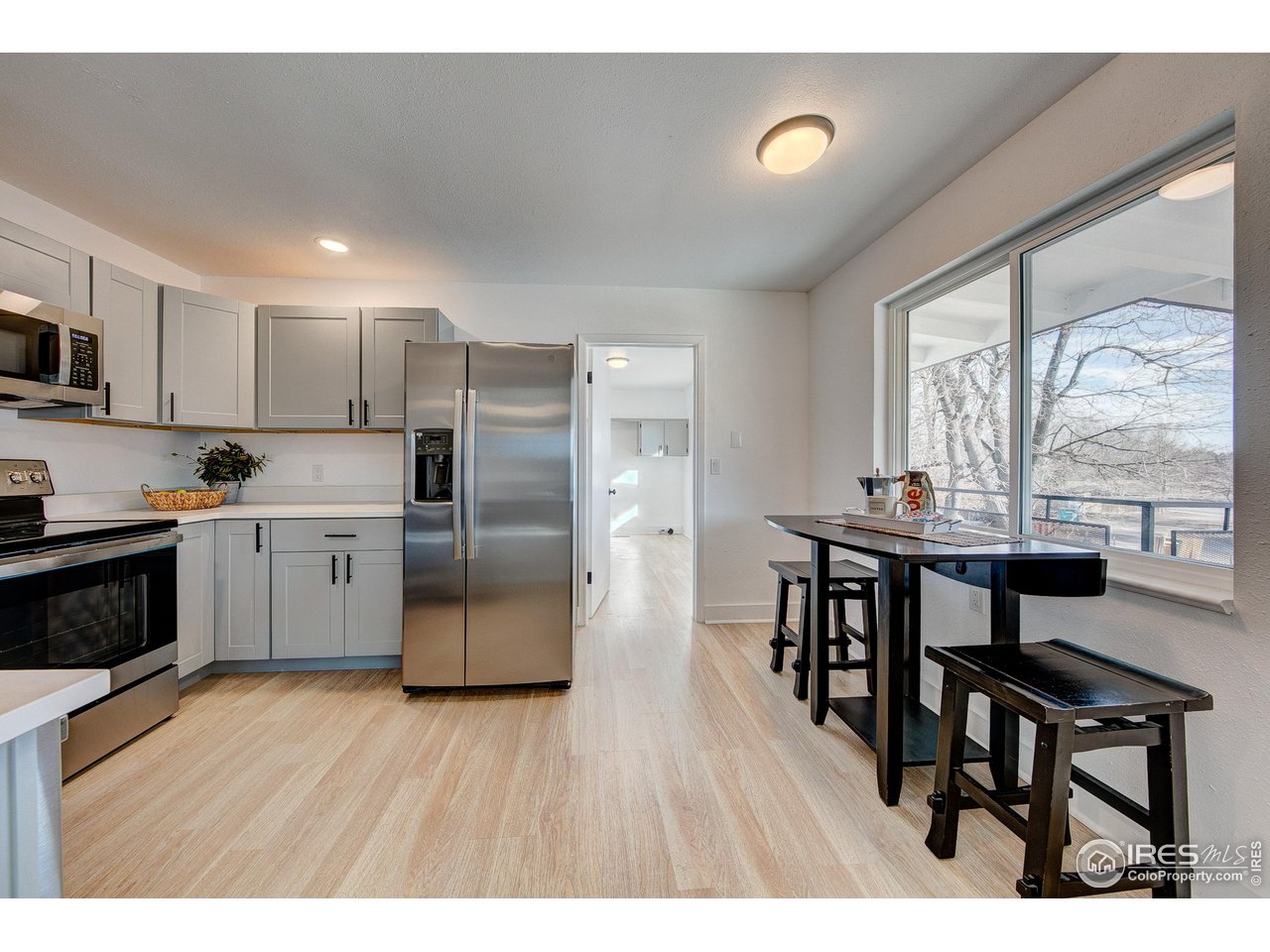 2017 Evergreen Drive Fort Collins, CO 80521 - Photo 6 of 33 a kitchen with stainless steel appliances granite countertop a stove top oven a sink dishwasher a dining table and chairs with wooden floor