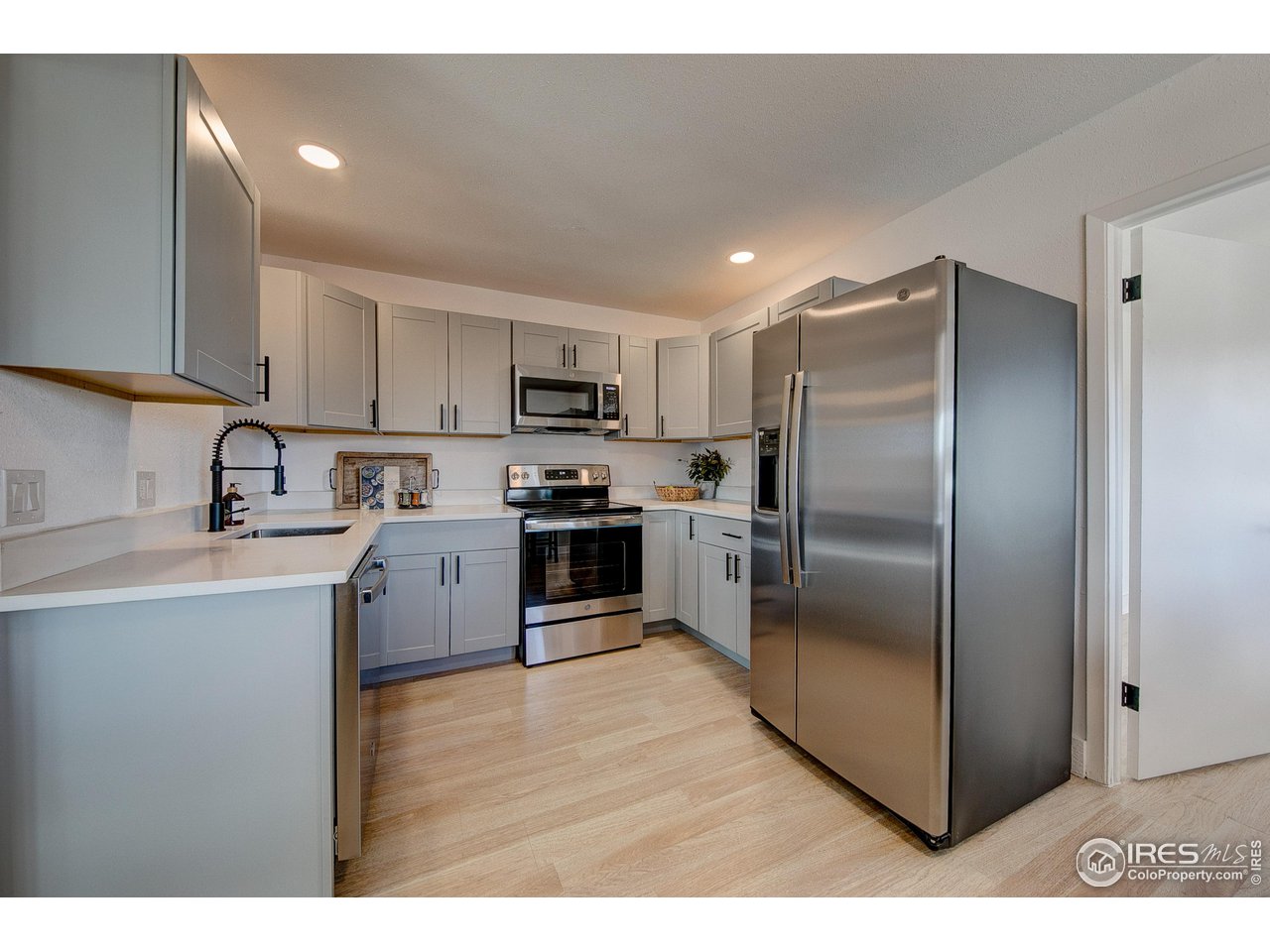 2017 Evergreen Drive Fort Collins, CO 80521 - Photo 7 of 33 a kitchen with kitchen island a counter top space cabinets and stainless steel appliances