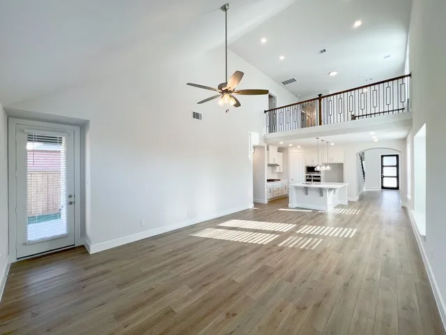 a view of a house with wooden floor and a ceiling fan