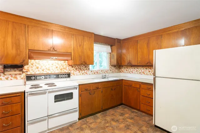 a kitchen with a white cabinets and white appliances