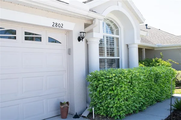a view of a house with potted plants