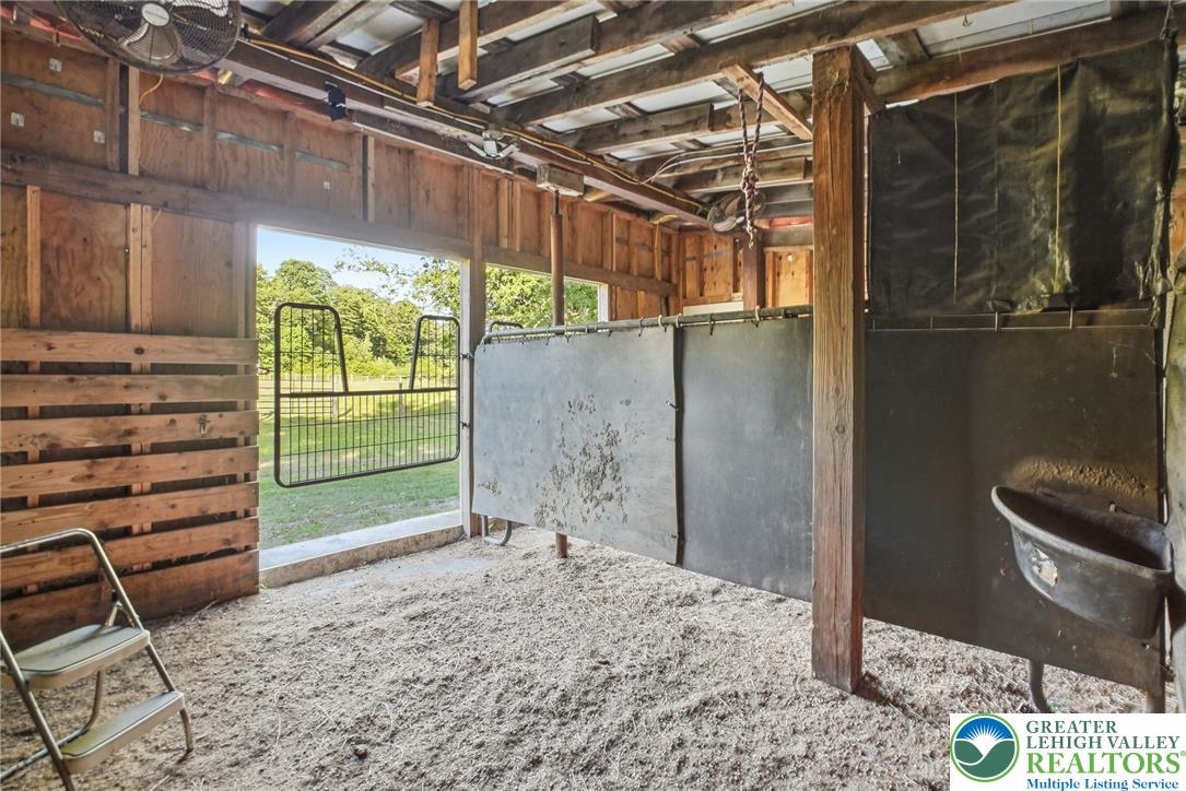 9033 Loop Road Slatington, PA 18080 - Photo 10 of 53 A well-ventilated stable with natural light offers a comfortable space for equestrian needs.