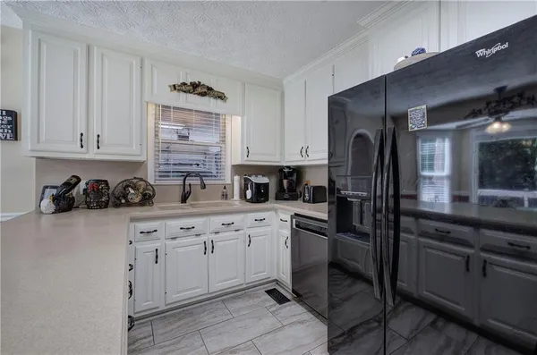 a kitchen with a sink cabinets and stainless steel appliances