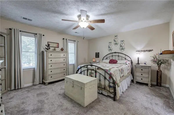 a bedroom with bed and a chandelier