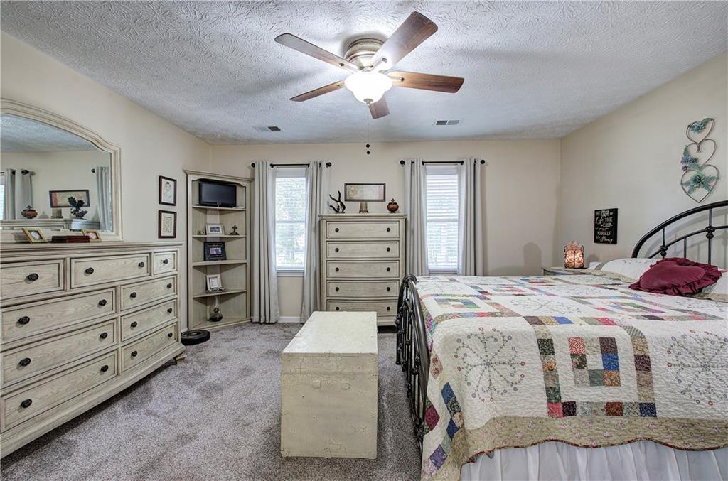 338 East Valley Road Northeast Rydal, GA 30171 - Photo 20 of 53 a bedroom with a bed and a dresser