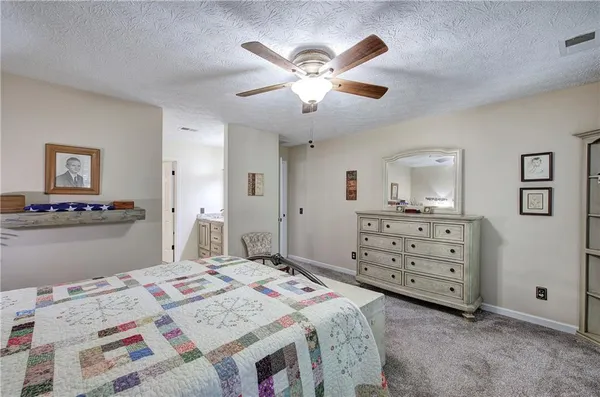 a bed room with a bed and a dresser