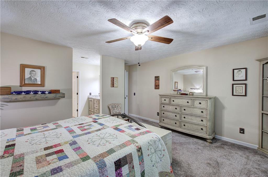 338 East Valley Road Northeast Rydal, GA 30171 - Photo 21 of 53 a bed room with a bed and a dresser