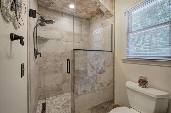 a bathroom with a shower toilet and sink