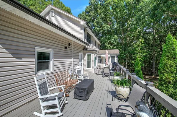 a view of backyard with outdoor seating and plants