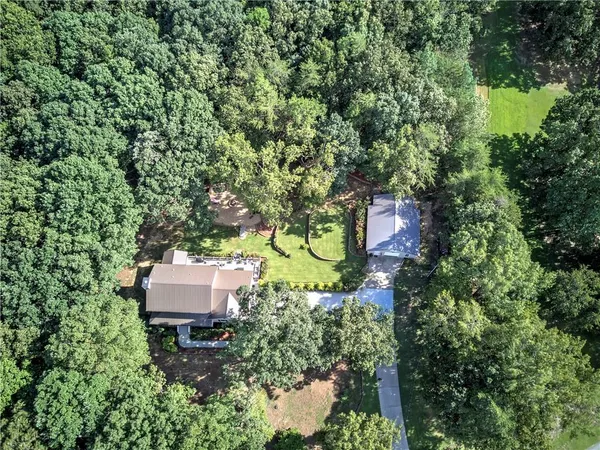 an aerial view of house with yard and outdoor seating