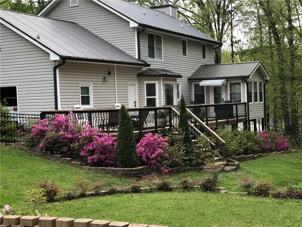 a view of a wooden deck with large trees