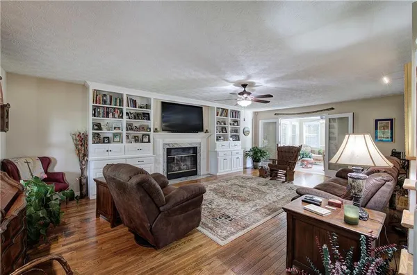 a living room with furniture a fireplace and a flat screen tv