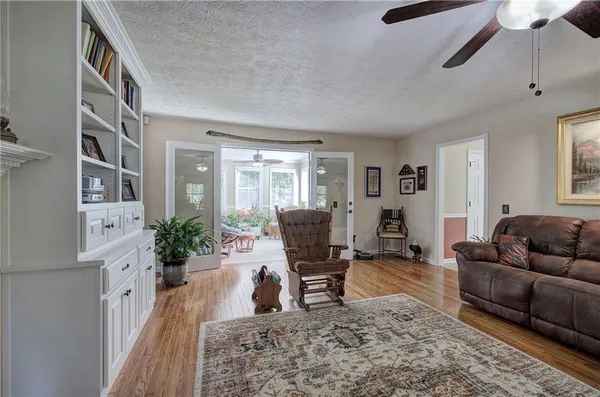 a living room with furniture rug and a window