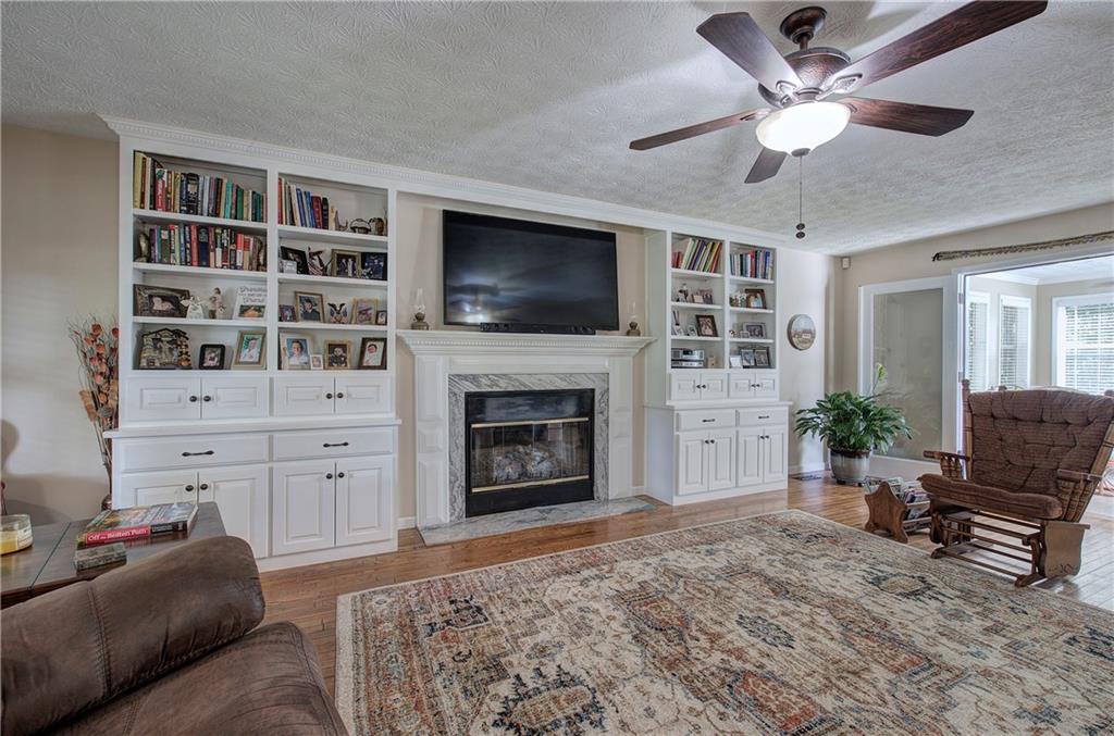 338 East Valley Road Northeast Rydal, GA 30171 - Photo 8 of 53 a living room with furniture a flat screen tv and a fireplace