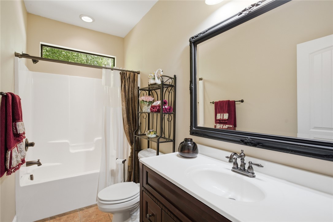 215 Inlet Pointe Drive Anderson, SC 29625 - Photo 16 of 47 This bathroom features a sleek vanity and a tub with an overhead window.